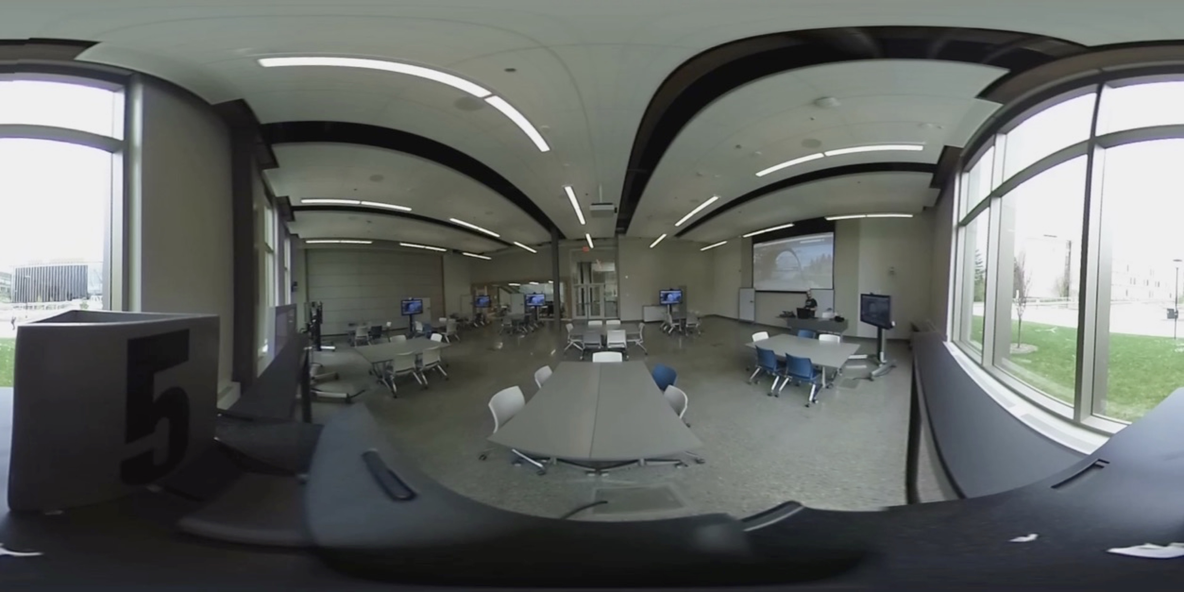 After developing a prototype and testing the technology to see if it was feasible for this use, I then recorded 360 ̊ videos within a classroom at the Taylor Institute for Teaching and Learning. The still image in figure 4.5 demonstrates the severe warping that occurs as a result of the panoramic lens and the resulting transformation of the 360 ̊ image into a 2-dimensional format to be saved on the camera.